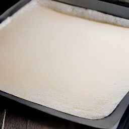 the puff pastry base is pressed into the baking tray (edges) using fingers.