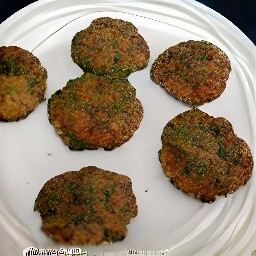 the veggie patties are transferred to a plate.