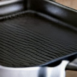 the griddle pan is heated on the stove.