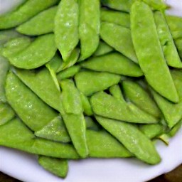 a platter of stir-fried snow peas with ginger, soy sauce, and sesame oil.