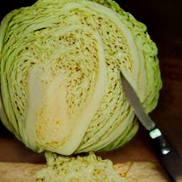 a bowl of peeled sweet onions and chopped cabbage.