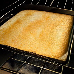 the jelly roll pan placed in a hot oven and baked for 7 minutes. then, the grated cheddar cheese sprinkled on top of the jelly roll pan. the jelly roll pan returned to the oven and baked
