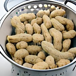 the green peanuts are drained in a colander.