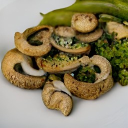 the spicy mushrooms with ginger and chilies are transferred to a serving plate.